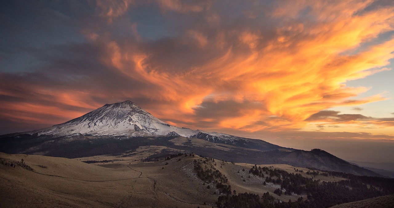 orange sun on a cloudy mountain sky